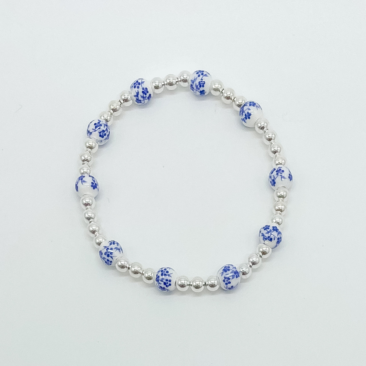 floral bracelet, beaded bracelet, elastic bracelet, statement bracelet, sterling silver bracelet, fall collection, fall accessories, stackable jewelry, dainty jewelry, essbe, small business, handmade, michigan made, blue porcelain looking bracelet beads