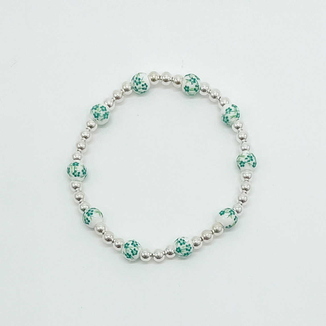 floral bracelet, beaded bracelet, elastic bracelet, statement bracelet, sterling silver bracelet, fall collection, fall accessories, stackable jewelry, dainty jewelry, essbe, small business, handmade, michigan made, green porcelain looking bracelet beads