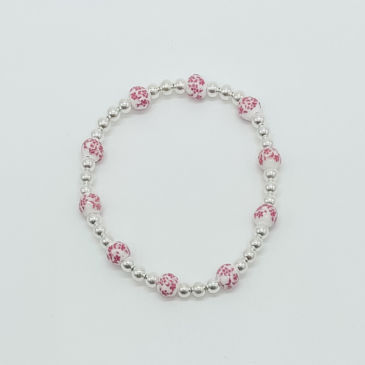 floral bracelet, beaded bracelet, elastic bracelet, statement bracelet, sterling silver bracelet, fall collection, fall accessories, stackable jewelry, dainty jewelry, essbe, small business, handmade, michigan made, pink porcelain looking bracelet beads, pink floral bracelet