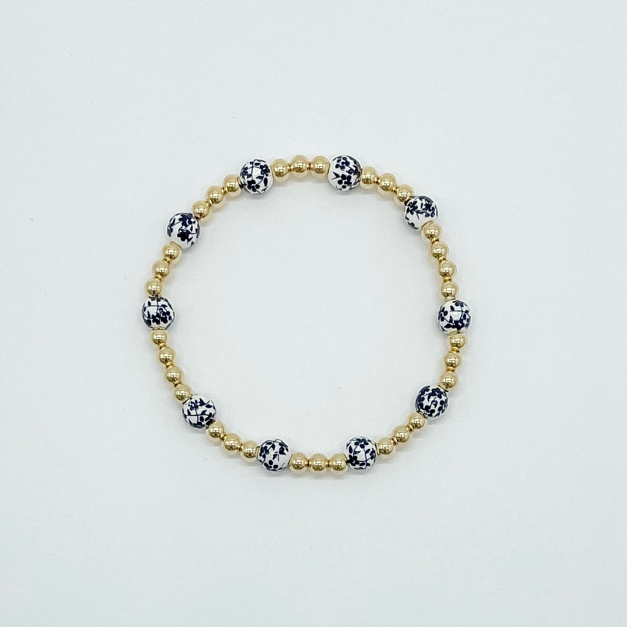 floral bracelet, beaded bracelet, elastic bracelet, statement bracelet, 14k gold filled bracelet, fall collection, fall accessories, stackable jewelry, dainty jewelry, essbe, small business, handmade, michigan made, navy porcelain looking bracelet beads