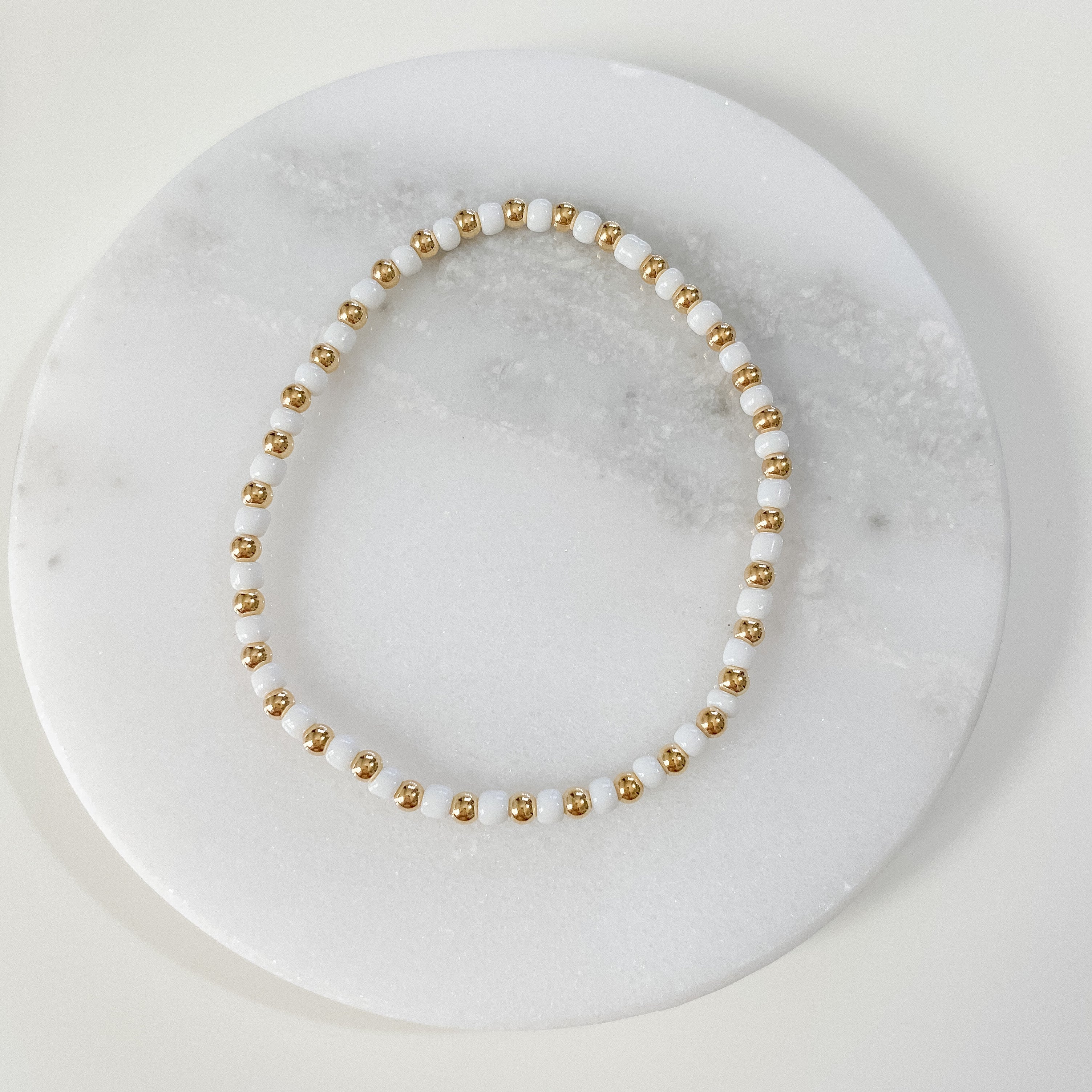 Seeded beaded bracelet, white, made in michigan, gold-filled bracelet, small business, essbe, handmade, dainty jewelry, stackable jewelry, elastic bracelet, beaded bracelet, gold-filled bracelet