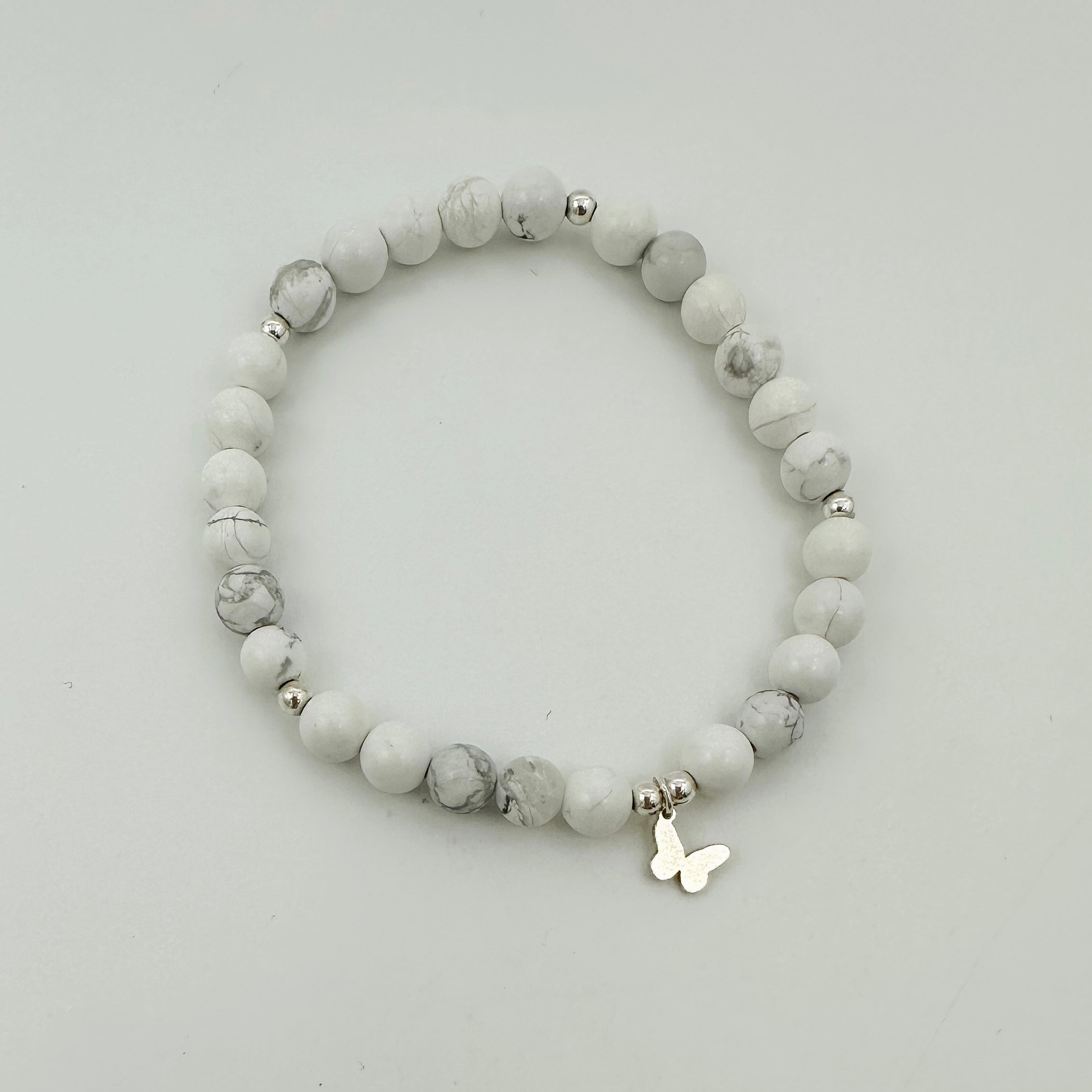 Paige bracelet, howlite beads, small business, handmade, dainty bracelet, stackable bracelet, sterling silver spacer beads, butterfly charm, elastic bracelet, stretchy bracelet, michigan made, essbe